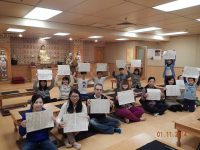 City 1 members doing Sutra Calligraphy